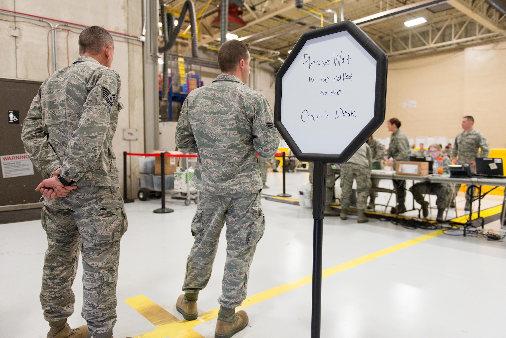 Members of the 934th Airlift Wing wait their turn for mass physicals at the fuel cell hangar on April 2. 