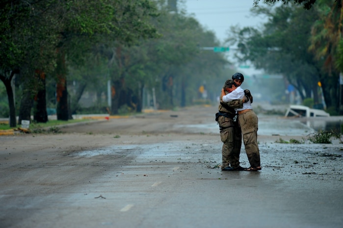U.S. Air Force Pararescueman Staff Sgt. Lopaka Mounts, assigned to the 331st Air Expeditionary Group receives a hug from a resident during search and rescue operations after Hurricane Ike,  September 13, 2008. This photograph was provided by the 1st Combat Camera Squadron to showcase world events they have documented throughout the past 25 years.

