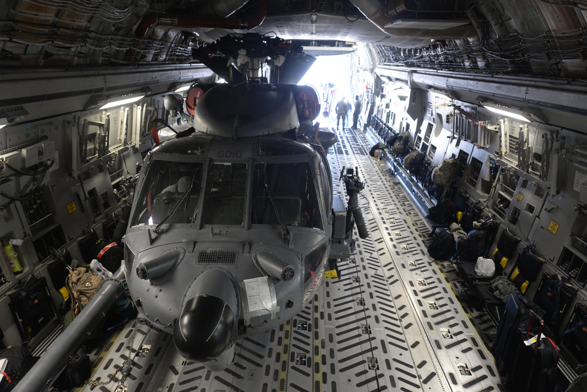 An HH-60 Pave Hawk helicopter, assigned to the 34th Weapons Squadron, sits inside a C-17 Globemaster III, assigned to the 57th Weapons Squadron, McChord Air Force Base, Wash., at Nellis Air Force Base, Nev., March 28, 2017. The HH-60 is the primary search-and-rescue helicopter for the Air Force, and can also be tasked with disaster and humanitarian relief missions. (U.S. Air Force photo by Airman 1st Class Andrew D. Sarver/ Released)