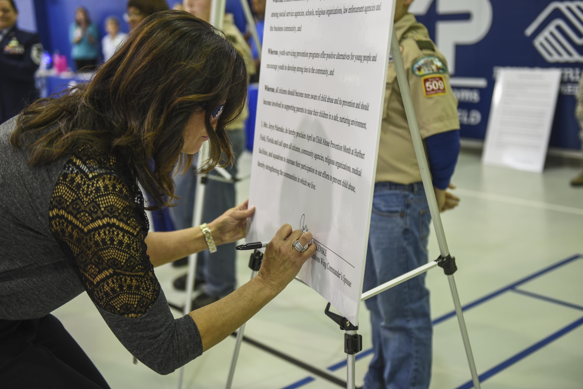 Jeryn Palenske, spouse of Col. Thomas Palenske, the commander of the 1st Special Operations Wing, signs the Child Abuse Prevention Month Proclamation during a ceremony at the Youth Center, Hurlburt Field, Fla., April 3, 2017. Palenske and his wife, Jeryn, both signed proclamations for MOMC and Child Abuse Prevention Month. (U.S. Air Force photo by Senior Airman Jeff Parkinson)