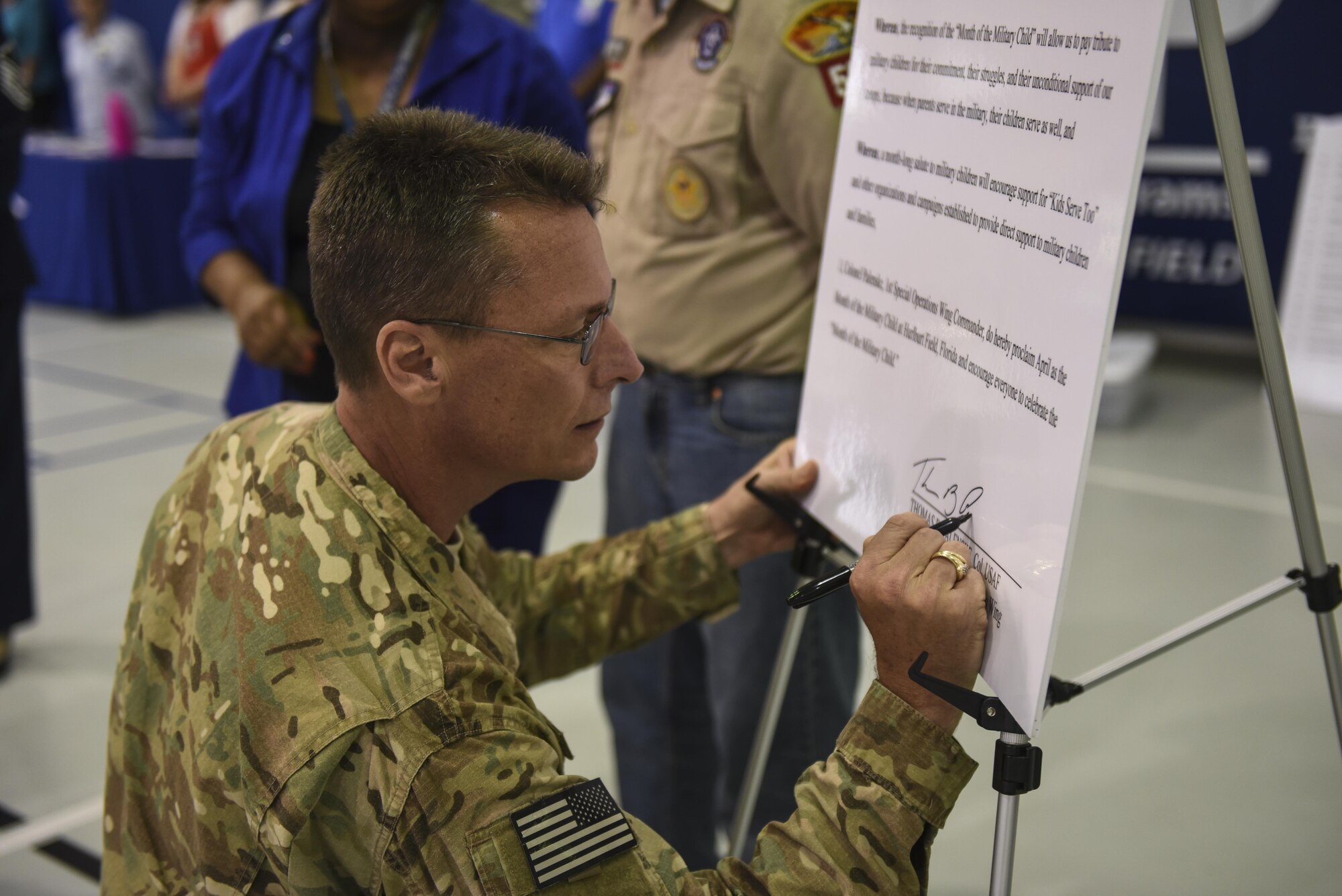 Col. Thomas Palenske, the commander of the 1st Special Operations Wing, signs the Month of the Military Child Proclamation during a ceremony at the Youth Center, Hurlburt Field, Fla., April 3, 2017. Palenske and his wife, Jeryn, both signed proclamations for MOMC and Child Abuse Prevention Month. (U.S. Air Force photo by Senior Airman Jeff Parkinson)