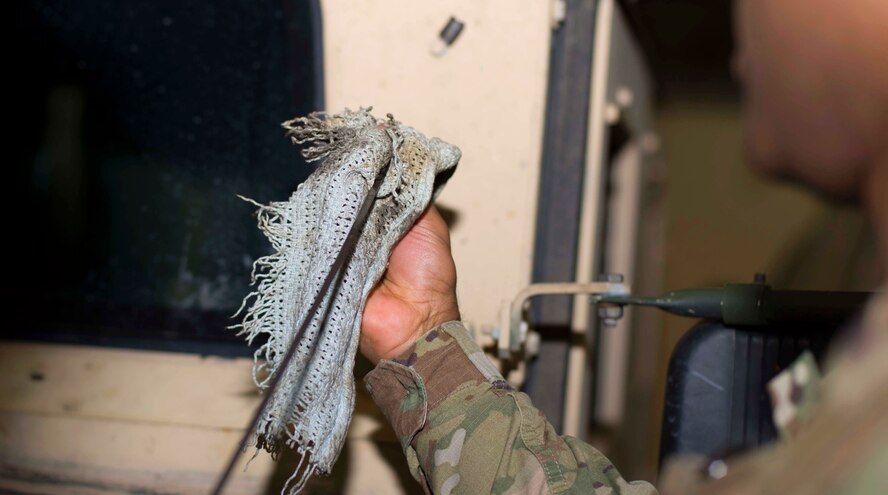 Staff Sgt. Calvin Smith, 91st Missile Security Force Squadron flight security controller, cleans a dipstick to check a Humvee’s fluids at Minot Air Force Base, N.D., Mar. 28, 2017. Security forces members are required to inspect all vehicles prior to use. (U.S. Air Force photo/Airman 1st Class Austin M. Thomas)