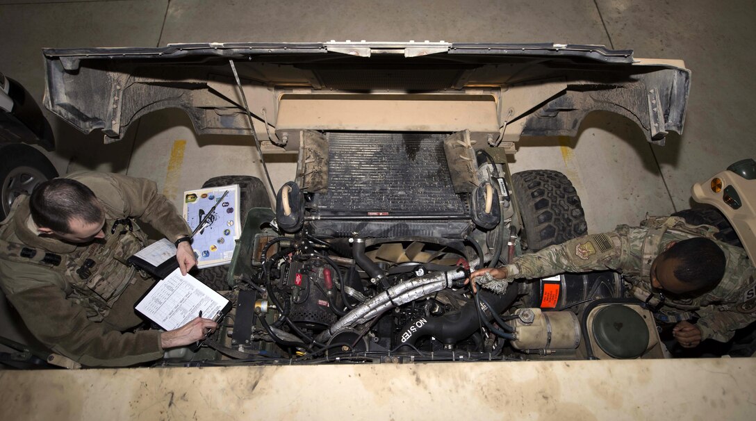 Senior Airman Michael Ripple, 791st Missile Security Forces Squadron response force leader, and Staff Sgt. Calvin Smith, 91st Missile Security Force Squadron flight security controller, inspect the engine of a Humvee at Minot Air Force Base, N.D., Mar. 28, 2017. To ensure a vehicles longevity, Airmen performed a detailed inspection before going out to the field. (U.S. Air Force photo/Airman 1st Class Austin M. Thomas)