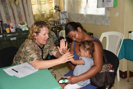 Sgt. 1st Class Loraine Branson, Joint Task Force-Bravo’s Medical Element, high fives a local Nicaraguan child during the screening process at Medical Readiness Exercise in the village of Waspam March 30. Personnel from the Joint Task Force-Bravo Medical Element worked side by side with local nurses and physicians, as well as Nicaraguan soldiers to provide the population with immunizations, preventive medicine, dental services, basic medical care and pharmacy services during the three day exercise. (U.S. Air Force photo by Capt. Denise Hauser)