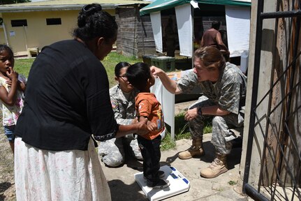 Lt. Col. Rhonda Dyer, a community health nurse with Joint Task Force-Bravo’s Medical Element, gives de-working medication to a local Nicaraguan child during a Medical Readiness Exercise held in the village of Waspam March 28-31. Pfc. JoAnna Rodriguez helps to weigh all the children at the Preventive Health Station. (U.S. Air Force photo by Capt. Denise Hauser)