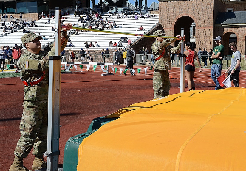 U.S. Army Pvts. Jose Casas and Alec Salazar, Echo Company, 266th Quartermaster Battalion, 23rd Quartermaster Brigade advanced individual training students, adjust the height of the high jump bar during a track and field meet at the College of William and Mary in Williamsburg, Va., April 1, 2017. The AIT Soldiers from Echo Co. supported the event, which hosted 65 different colleges and universities, as well as 34 high school teams from six states. (U.S. Air Force photo/Staff Sgt. Teresa J. Cleveland)