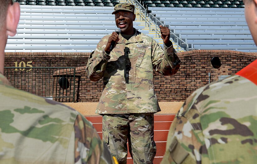 U.S. Army Capt. Jamar Jenkins, Echo Company, 266th Quartermaster Battalion, 23rd Quartermaster Brigade commander, conducts a promotion ceremony for three Soldiers during a track and field meet at the College of William and Mary in Williamsburg, Va., April 1, 2017. Along with the promotion ceremony, the Soldiers volunteered at various stations and participated in a relay race to promote esprit de corps within their unit and demonstrate unit physical capabilities. (U.S. Air Force photo/Staff Sgt. Teresa J. Cleveland)