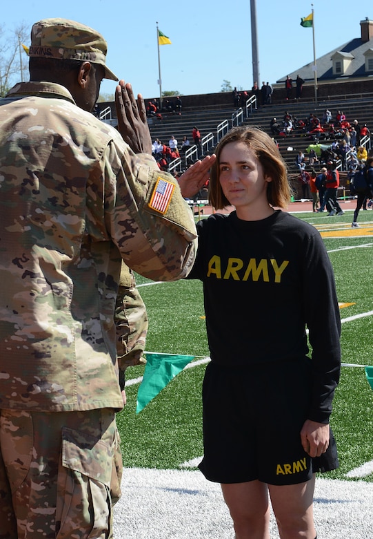 U.S. Army Capt. Jamar Jenkins, Echo Company, 266th Quartermaster Battalion, 23rd Quartermaster Brigade commander, salutes U.S. Army Pvt. Tory Hamton, Echo Co., 266th Quartermaster Btn., 23rd Quartermaster Bde. advanced individual training student, after her promotion during a track and field meet at the College of William and Mary in Williamsburg, Va., April 1, 2017. Two other Soldiers also promoted during the ceremony, where Jenkins spoke of the promising future to the Soldiers.  (U.S. Air Force photo/Staff Sgt. Teresa J. Cleveland)