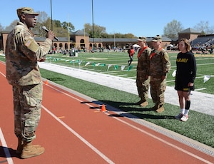 U.S. Army Capt. Jamar Jenkins, Echo Company, 266th Quartermaster Battalion, 23rd Quartermaster Brigade commander, conducts a promotion ceremony for three Soldiers during a track and field meet at the College of William and Mary in Williamsburg, Va., April 1, 2017. Jenkins thanked the audience and event participants for their support of the military community and congratulated the three Soldiers on their success. (U.S. Air Force photo/Staff Sgt. Teresa J. Cleveland)