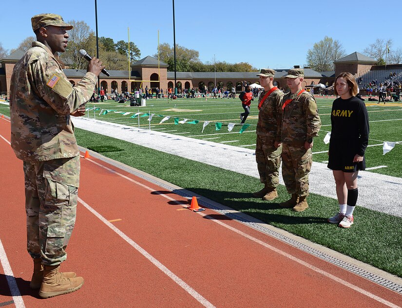 U.S. Army Capt. Jamar Jenkins, Echo Company, 266th Quartermaster Battalion, 23rd Quartermaster Brigade commander, conducts a promotion ceremony for three Soldiers during a track and field meet at the College of William and Mary in Williamsburg, Va., April 1, 2017. Jenkins thanked the audience and event participants for their support of the military community and congratulated the three Soldiers on their success. (U.S. Air Force photo/Staff Sgt. Teresa J. Cleveland)