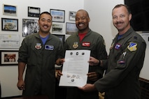 The 6th Attack Squadron commander (left), 29th Attack Squadron commander, and 9th Attack Squadron commander, display the Reaper Armistice Agreement after they signed the document March 31, 2017, at Holloman Air Force Base, N.M. The Reaper Armistice Agreement is an esprit de corps arrangement between the three squadrons that marks the neutral time when the capture of non-mission essential belongings from a different attack squadron, in the name of competitive spirit, isn’t allowed at Holloman AFB. (U.S. Air Force photo by Master Sgt. Matthew McGovern)
