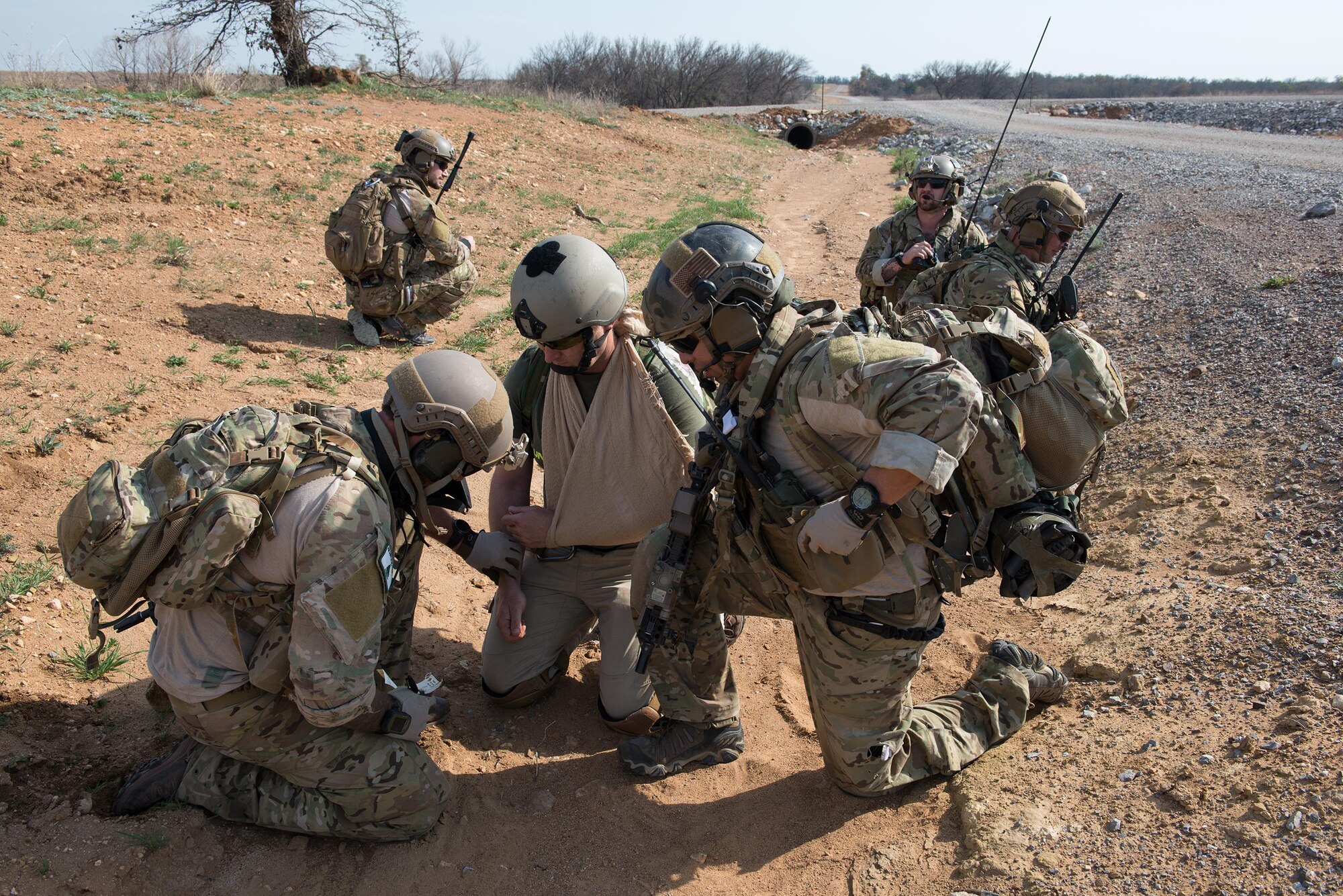 Pararescue Airmen from the 123rd Special Tactics Squadron, Kentucky Air National Guard, provide simulated first-aid to a simulated wound during a joint training event at Falcon Bombing Range, Fort Sill, Okla., March 22, 2017. The 137th Air Support Element from the 137th Special Operations Wing, Oklahoma City, coordinated a joint training event with the 123rd Special Tactics Squadron, Kentucky Air National Guard, Air Force Reserve F-16 Fighting Falcons from the 301st Fighter Wing and T-38 Talons from the 88th Fighter Training Squadron, Sheppard Air Force Base, March 20-23, 2017. (U.S. Air National Guard photo by Senior Master Sgt. Andrew M. LaMoreaux/Released)