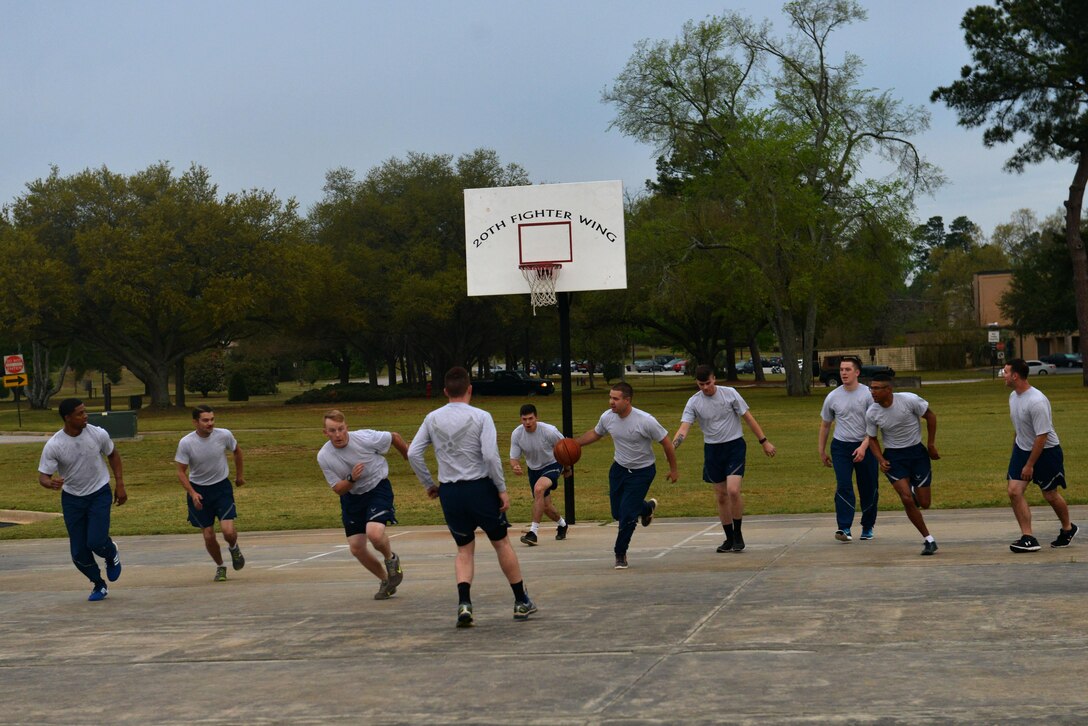 U.S. Airmen assigned to the 20th Logistics Readiness Squadron vehicle maintenance flight play basketball at Shaw Air Force Base, S.C., April 5, 2017. Unit physical training can promote teamwork and improve physical fitness, supporting the physical and social domains of Comprehensive Airmen Fitness. (U.S. Air Force photo by Airman 1st Class Destinee Sweeney)
