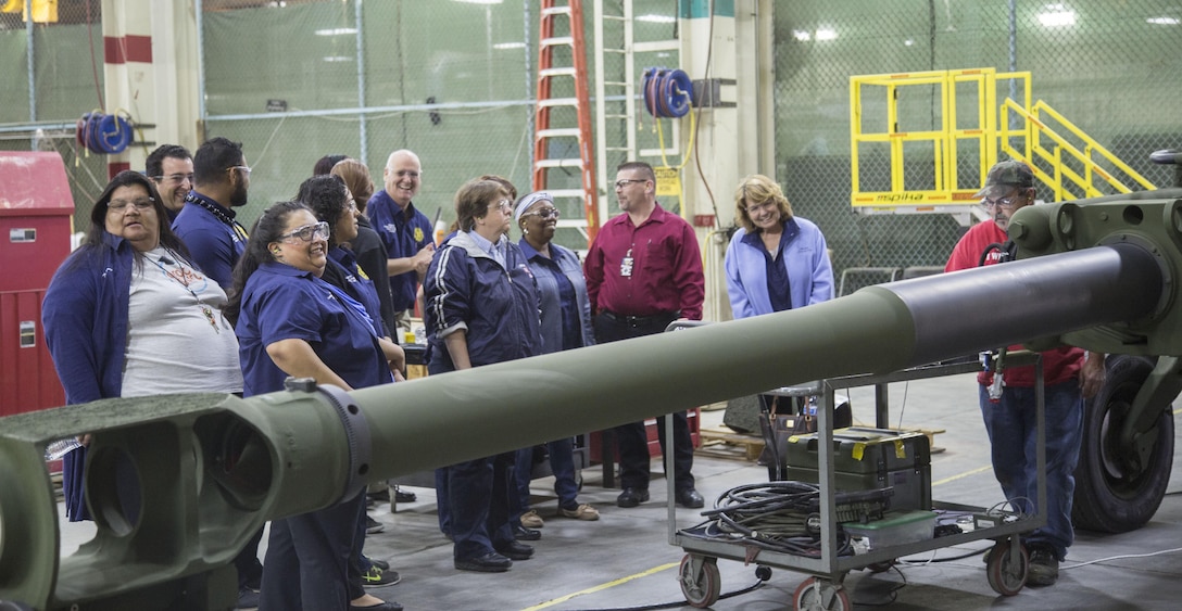 Will Beckley, Production Plant Barstow, Marine Depot Maintenace Command, explains to members of the Barstow Collge President's Leadership group the process for tearing down and rebuilding the M777 Howitzer, during the group's tour of MCLB Barstow, March 31. To Beckley's left is Dr. Debbie DiThomas,  president of Barstow Collge, who watching one of the plant's artisans at work.