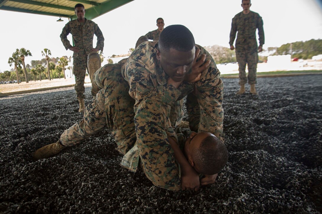 Sergeant Maurkees D. Wright, top, grapples with Staff Sgt. Wi McMullen during MCMAP training aboard Marine Corps Recruit Depot Parris Island, South Carolina, Apr. 5, 2017. MCMAP is a martial arts style in the Marine Corps that is a mixture of mixed martial arts and Judo. (U.S. Marine Corps photo by Lance Cpl. Jack A. E. Rigsby/Released)