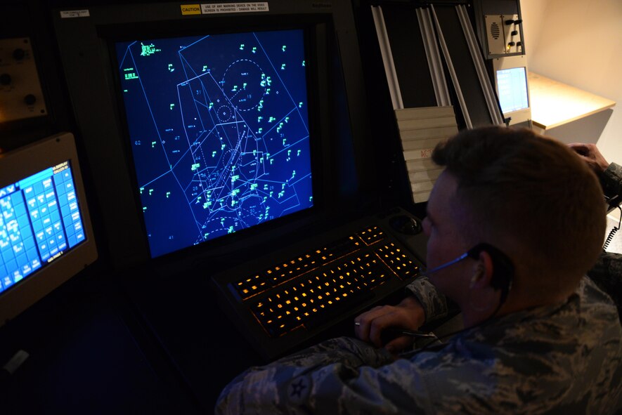 Airman Benjamin Cobb, 60th Operations Support Squadron, monitors air traffic over Travis Air Force Base, Calif., inside the Travis Radar Approach Control facility April 3, 2017. Travis air traffic controllers monitor an average of 367 aircraft daily. (U.S. Air Force photo/Tech. Sgt. James Hodgman/Released)