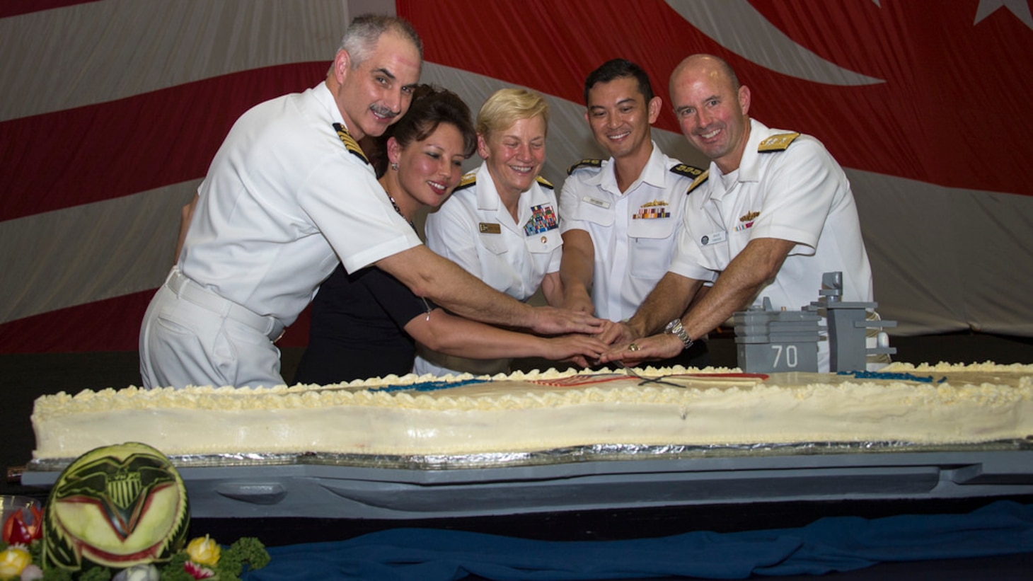 (left to right) USS Carl Vinson (CVN 70) commanding officer Capt. Doug Verissimo; Chargé d’Affaires, ad interim, U.S. Embassy Singapore Stephanie Syptak-Ramnath; Commander, U.S. Third Fleet Vice Adm. Nora Tyson; Commander, Singapore Fleet, Col. Cheong Kwok Chien; and Commander, Carrier Strike Group 1 Rear Adm. Jim Kilby cut the cake during a Singapore reception aboard the aircraft carrier USS Carl Vinson (CVN 70), April 4, 2017. The Carl Vinson Strike Group is on a regularly scheduled Western Pacific deployment as part of the U.S. Pacific Fleet-led initiative to extend the command and control functions of U.S. 3rd Fleet. U.S. Navy aircraft carrier strike groups have patrolled the Indo-Asia-Pacific regularly and routinely for more than 70 years.