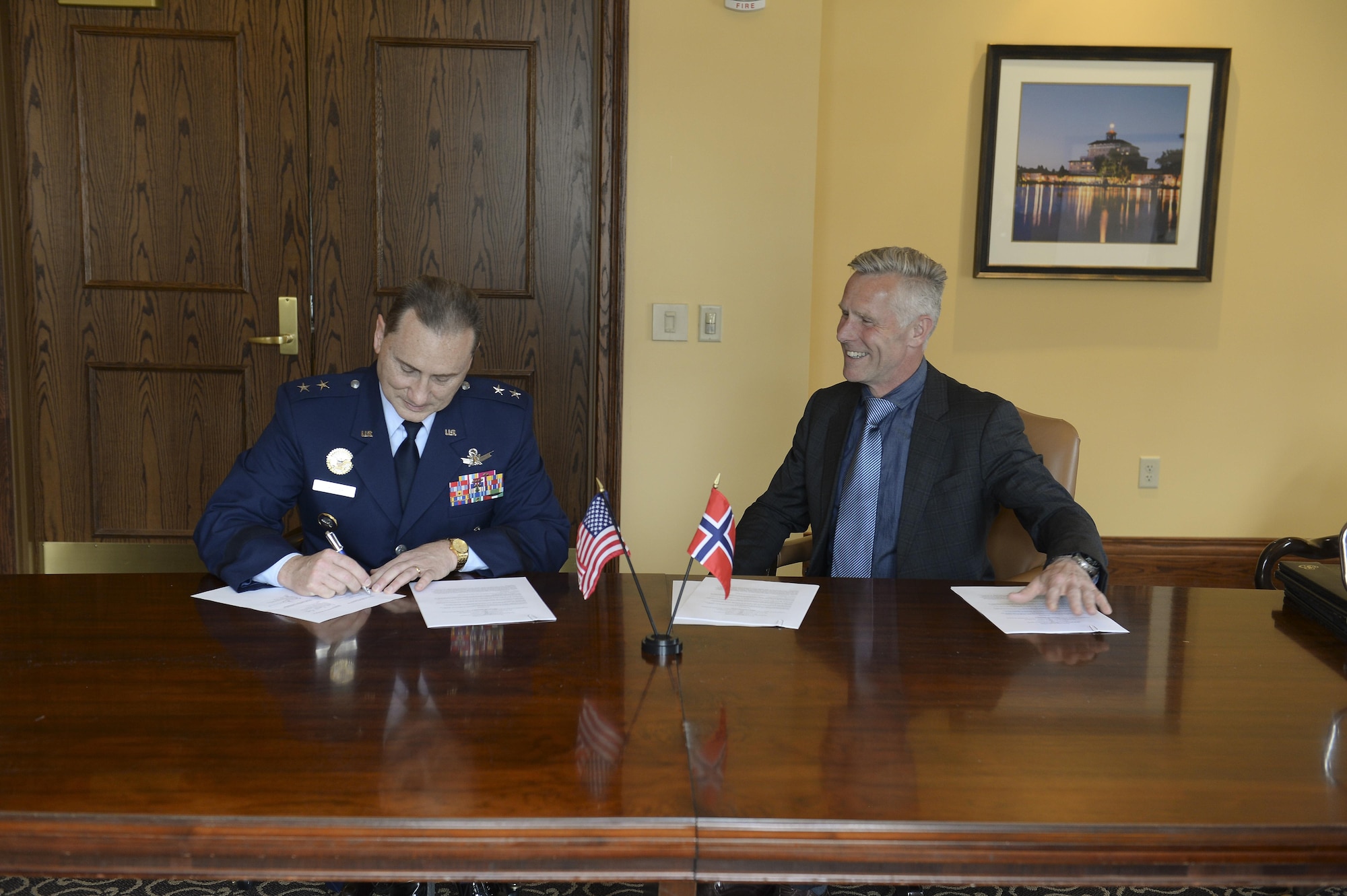 U.S. Air Force Maj. Gen. Clinton E. Crosier, the U.S. Strategic Command (USSTRATCOM) director of plans and policy, signs a memorandum of understanding with Royal Norwegian Air Force Col. Stig Nilsson, the Norwegian Ministry of Defense head of the space program, April 4, 2017, at the 33rd Annual Space Symposium, Colorado Springs, Colorado. The memorandum authorizes sharing space situational awareness (SSA) services and information with the Norwegian Ministry of Defense and Norwegian Ministry of Trade, Industry and Fisheries. (U.S. Air Force photo/ David Grim)