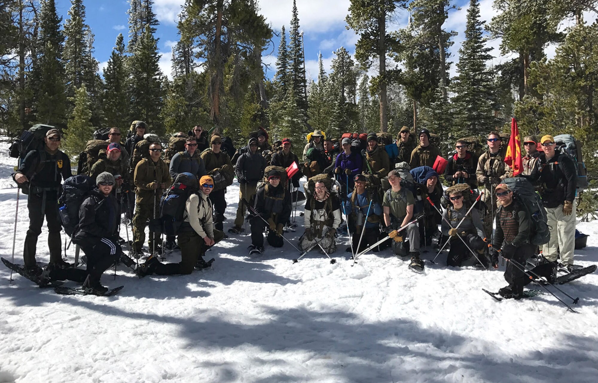 Company A, Marine Cryptologic Support Battalion and 460th Force Support Squadron Outdoor Recreation instructors from Buckley Air Force Base, Colo., pose for a photo near Beaver Meadows Resort Ranch April 2, 2017. The unit spent three days learning winter survival skills in cold-weather conditions. (U.S. Air Force photo by Airman Jacob Deatherage/Released)