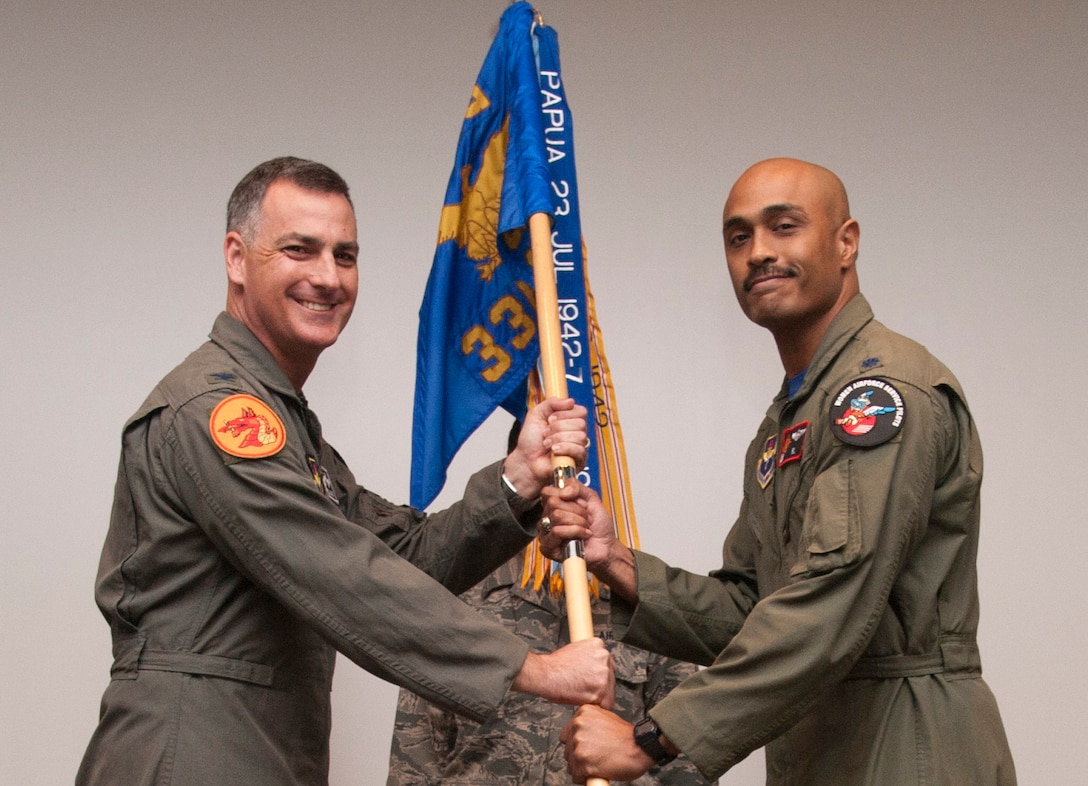 VANCE AIR FORCE BASE, Okla. -- Lt. Col. Mathew Elleby, right, assumes command of the 33rd Flying Training Squadron by accepting the unit’s guidon from Col. Paul Johnson, the 71st Operations Group commander, during a ceremony held March 31 at Vance Air Force Base, Oklahoma. Elleby previously served as the director of operations with the 71st Operations Support Squadron at Vance. The Dragons with the 33rd FTS train student pilots to fly the T-6A Texan II. (U.S. Air Force photo/ Tech. Sgt. James Bolinger)