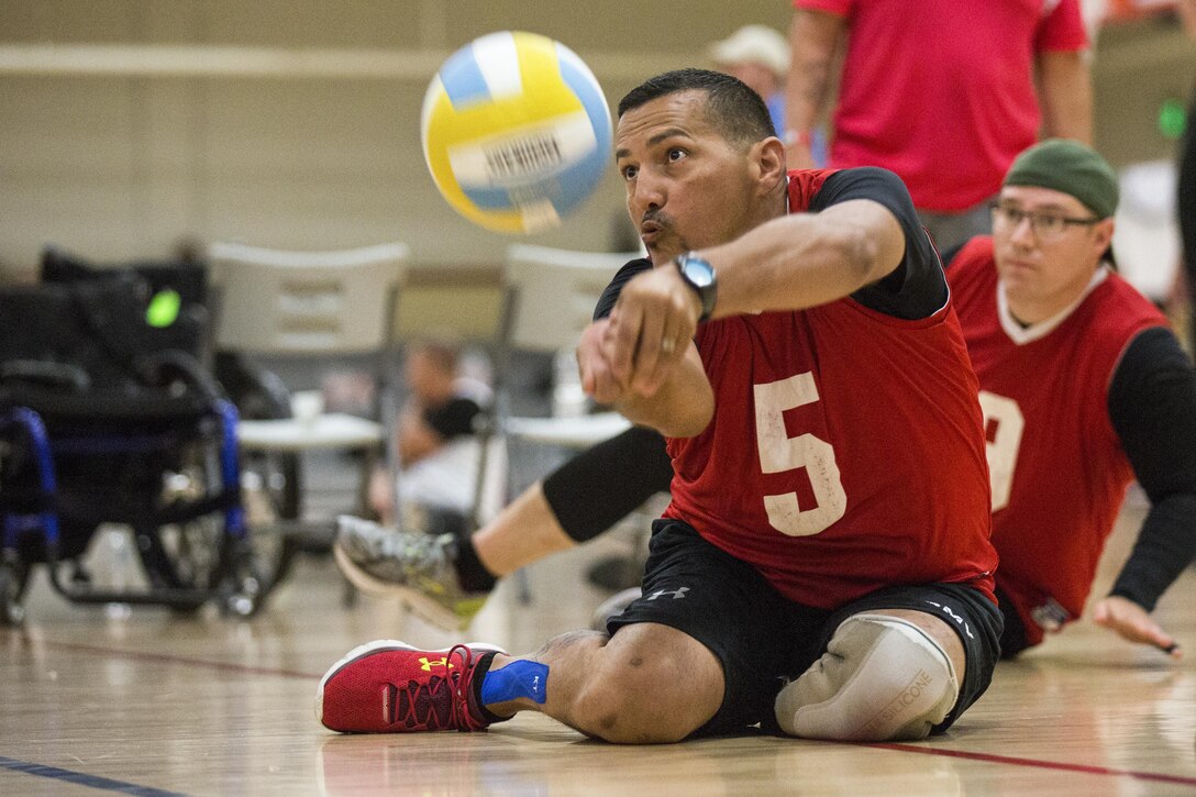 Army veteran Aristoles Colo trains for the sitting volleyball event for the Warrior Care and Transition's Army trials at Fort Bliss, Texas, April 3, 2017. About 80 wounded, ill and injured active-duty soldiers and veterans are competing in eight different sports to represent Team Army at the 2017 Department of Defense Warrior Games. Army photo by Pfc. Genesis Gomez