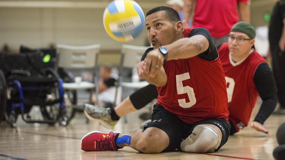 Army veteran Aristoles Colo trains for the sitting volleyball event for the Warrior Care and Transition's Army trials at Fort Bliss, Texas, April 3, 2017. About 80 wounded, ill and injured active-duty soldiers and veterans are competing in eight different sports to represent Team Army at the 2017 Department of Defense Warrior Games. Army photo by Pfc. Genesis Gomez