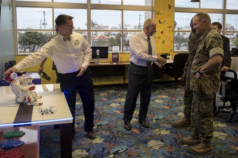 Devin Farmer, left, demonstrates the interactive robot to Gen. Robert B. Neller, commandant of the Marine Corps, April 4 at the Marine Corps Installations Pacific Innovation Lab aboard Camp Foster, Okinawa, Japan. The Innovation Lab features two Oculus Rifts, 3-D printers and an interactive robot among other state-of-the-art technology. Both Neller and Farmer hope that the Innovation Lab will spark creative thinking among Marines. Farmer is the supervisory librarian for the Camp Foster Library. (U.S Marine photo by Lance Corporal Tayler P. Schwamb)