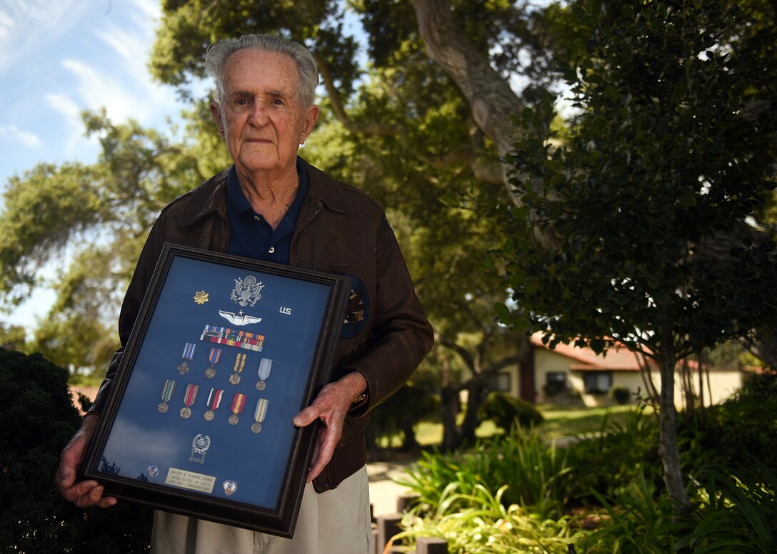 World War II fighter pilot and retired Air Force Maj. M. Eugene Johns, poses with his military decorations, April 5, 2017, Vandenberg Air Force Base, Calif. Vandenberg’s Pacific Coast Club will facilitate a commemorative toast performed by WWII combat aviators, and retired Air Force officers, Johns, who also goes by the name Gene, and Col. Ralph Jenkins, April 7. (U.S. Air Force photo by Michael Peterson/Released)