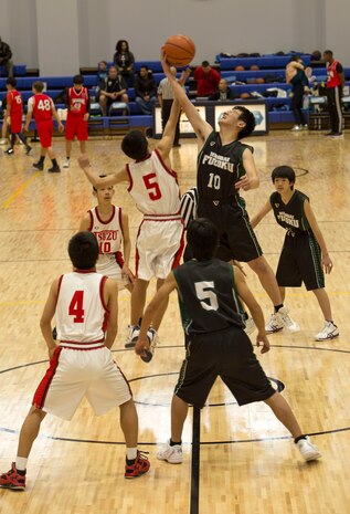 Tsuzu Junior High School and Hiroshima University Junior High School basketball teams start a game with a tip-off during the Friendly Basketball Tournament at Marine Corps Air Station Iwakuni, Japan, March 25, 2017. The tournament was composed of six junior high school teams and bridged the gap of two cultures by helping children make new friends through a common interest. (U.S. Marine Corps photo by Pfc. Stephen Campbell)