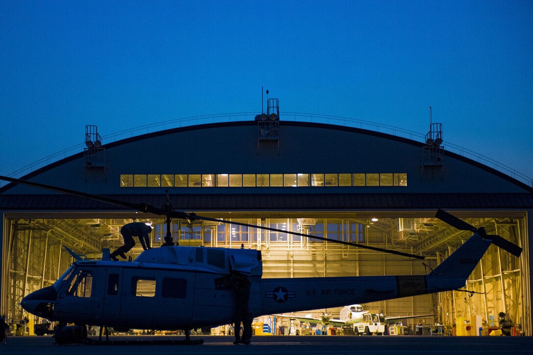 Aircrew for a UH-N1 Iroquois helicopter perform pre-flight checks prior to a 459th Airlift Squadron night hoist training exercise April 4, 2017, at Yokota Air Base, Japan. The 459 AS regularly conducts night training exercise to ensure mission readiness. (U.S. Air Force photo by Airman 1st Class Donald Hudson) 