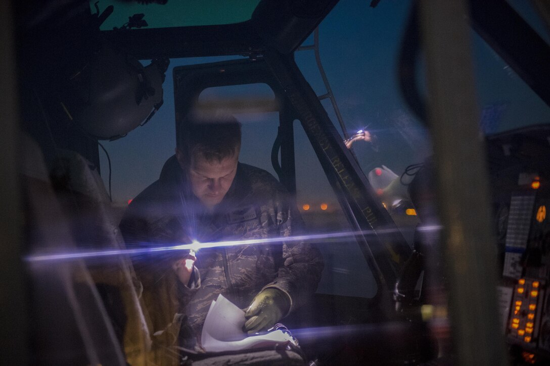 Capt. Jonathan W. Coffey, 459th Airlift Squadron pilot, performs final checks prior to a night hoist training exercise April 4, 2017, at Yokota Air Base, Japan. The hoist allows the 459 AS to conduct rescue missions in small, tight areas throughout the Kanto Plains. (U.S. Air Force photo by Airman 1st Class Donald Hudson) 