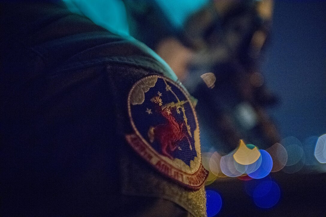 Staff Sgt. Nicholas A. Poe, 459th Airlift Squadron special mission’s aviator, looks out of a UH-1N Iroquois during a night hoist training exercise April 4, 2017, Tokyo, Japan. The hoist allows the 459 AS to conduct rescue missions in small, tight areas throughout the Kanto Plains. (U.S. Air Force photo by Airman 1st Class Donald Hudson) 