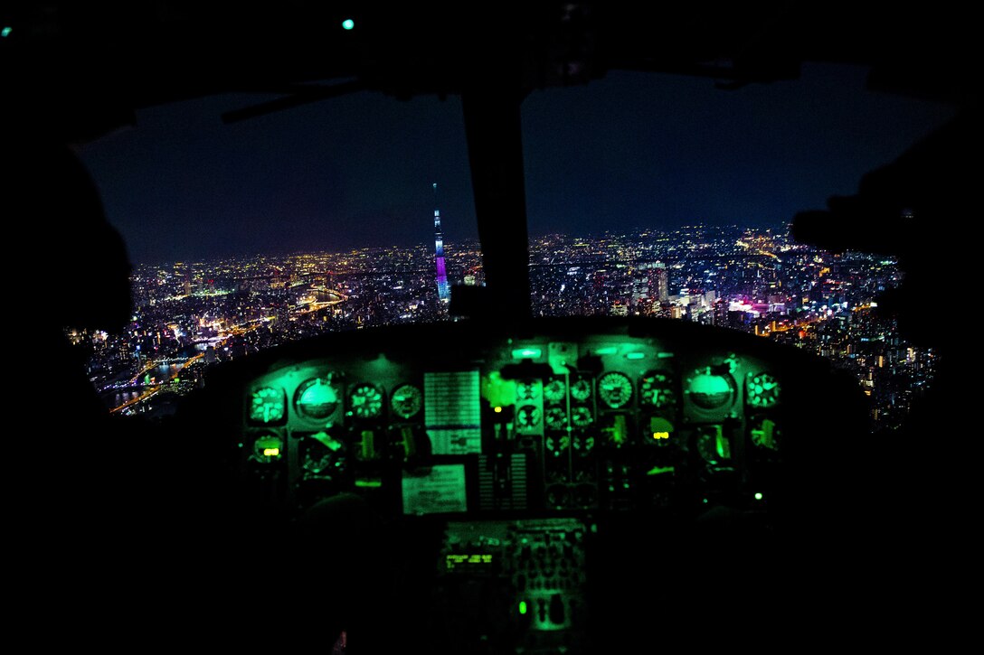 Aircrew fly towards Tokyo Tower during a 459th Airlift Squadron night hoist training exercise April 4, 2017, Tokyo, Japan. The training also included various landing and takeoff techniques throughout landing zones in the Tokyo metropolitan area. (U.S. Air Force photo by Airman 1st Class Donald Hudson) 
