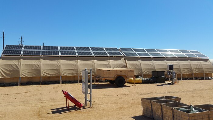 Part of AFRL's Forward Operating Base of the Future demonstration is one complete expeditionary microgrid system at Basic Expeditionary Airmen Skills Training (BEAST), Lackland AFB, San Antonio, Texas. Monocrystalline silicon solar panels are placed on top of each tent for energy production. A trailer (center) holds the hardware, software and lithium ion batteries that form the smart grid and provide energy backup should the grid fail. The project evaluates energy reduction technologies such as shelter insulation and efficient HVACs. (U.S. Air Force photo/Jason Goins)