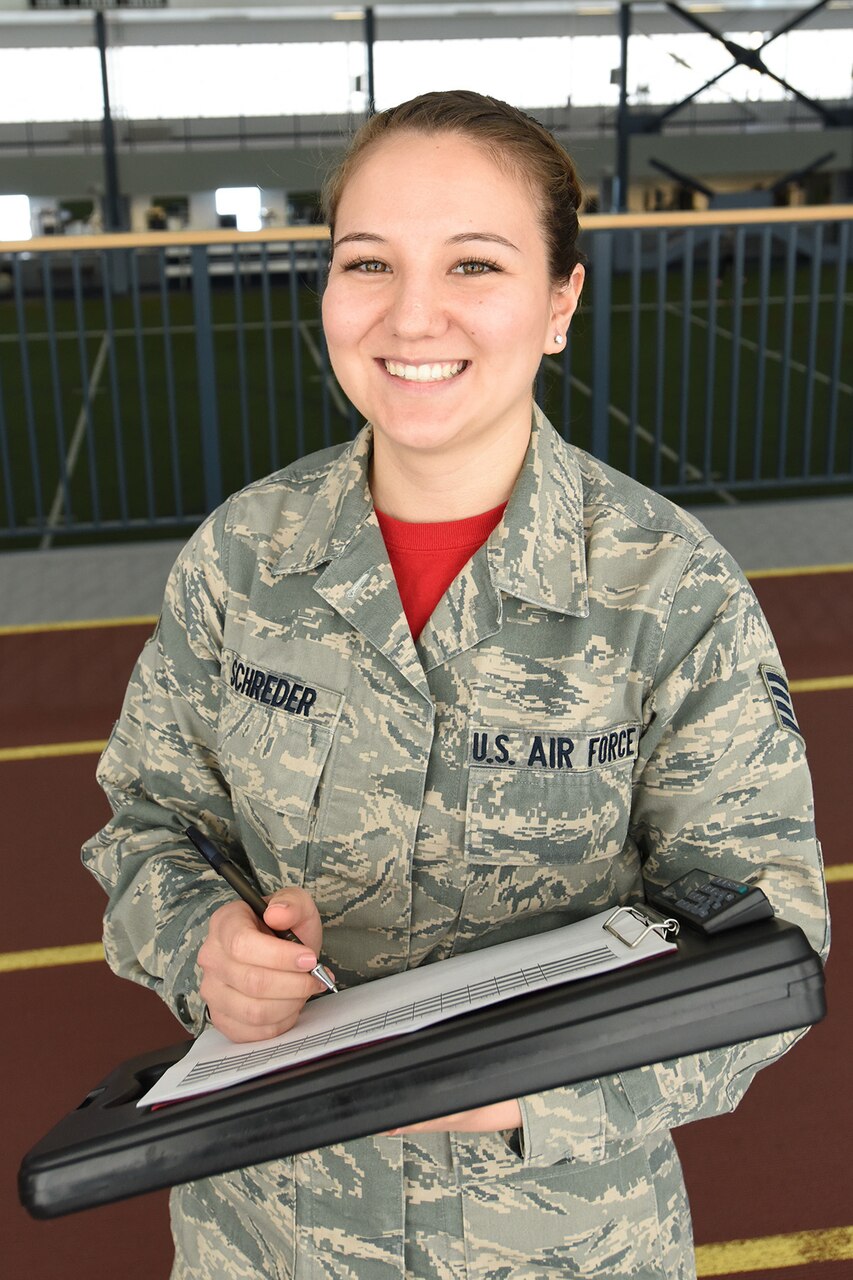 Staff Sgt. Megan Schreder, services craftsman for the 168th Force Support Flight, Alaska Air National Guard, Eielson AFB, Alaska, administers fitness tests inside the Baker Field House, Eielson AFB, Alaska, April 2, 2017. Schreder, when not wearing Air Force camouflage, is a full-time elementary school teacher in Fairbanks, Alaska, and is in her second year of teaching. 