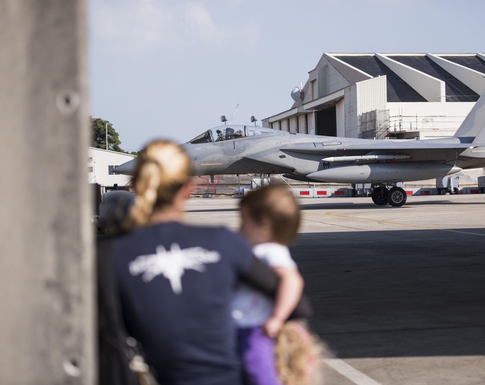 An U.S. Air Force F-15 Eagle from the 44th Fighter Squadron taxis on the flightline as family members watch for their loved ones to arrive from Cope Tiger 2017, April 3, 2017 at Kadena Air Base, Japan. The 44th FS participates in exercises like Cope Tiger to increase combat readiness in the Indo-Asia Pacific Theater.