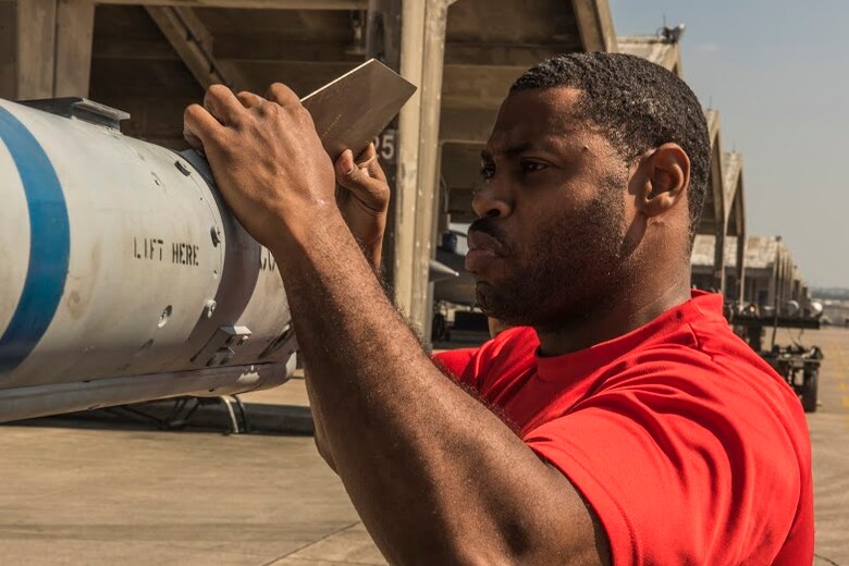 U.S. Air Force Staff Sgt. Jason Jones, 18th AMXS weapons load crew chief, secures an AIM-9L/M Sidewinder missile during a quarterly weapons load competition April 3, 2017, at Kadena Air Base, Japan. The competition was held between the 44th and 67th Aircraft Maintenance Units for quickest and most accurate loading of weapons on their respective aircraft. (U.S. Air Force photo by Senior Airman Nick Emerick/Released)