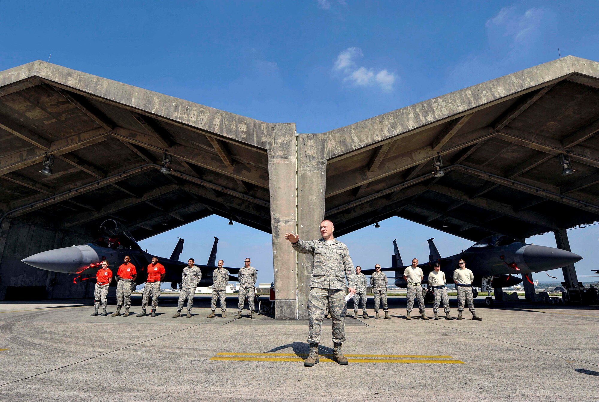 U.S. Air Force Tech. Sgt. Benjamin Bouvy, 18th Aircraft Maintenance Squadron weapons load standardization crew member, gives the opening remarks of a quarterly weapons load competition April 3, 2017, at Kadena Air Base, Japan. The competition was held between the 44th and 67th Aircraft Maintenance Units for quickest and most accurate loading of weapons on their respective aircraft. (U.S. Air Force photo by Naoto Anazawa/Released)