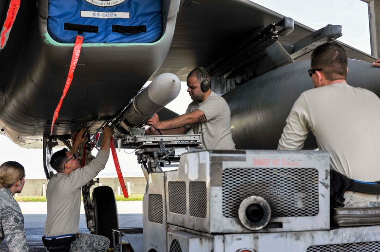 A U.S. Air Force weapons load crew team from the 44th Aircraft Maintenance Unit secure an AIM-120 advanced medium-range air-to-air missile to an F-15 Eagle fighter aircraft during a quarterly weapons load competition April 3, 2017, at Kadena Air Base, Japan. The competition evaluated safety, reliability and effectiveness while adhering to technical data and explosive safety. (U.S. Air Force photo by Naoto Anazawa/Released)