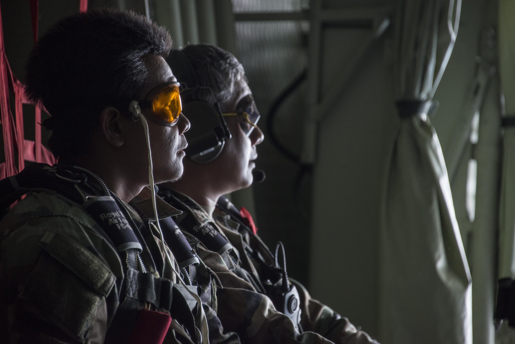 Combat controllers assigned to the Royal Thai Air Force 3rd Battalion Special Operations Regiment look out the back of a U.S. Air Force MC-130H Talon II in preparation for jump operations, March 13, 2017 at Prachuap Khiri Khan, Thailand. Air commandos from the 1st Special Operations Squadron provided personnel and cargo drops for RTAF 3rd BN SOR and U.S. Air Force 6th SOS during the last week of Teak Torch 2017, which culminated in a full mission profile. (U.S. Air Force photo by Capt. Jessica Tait)