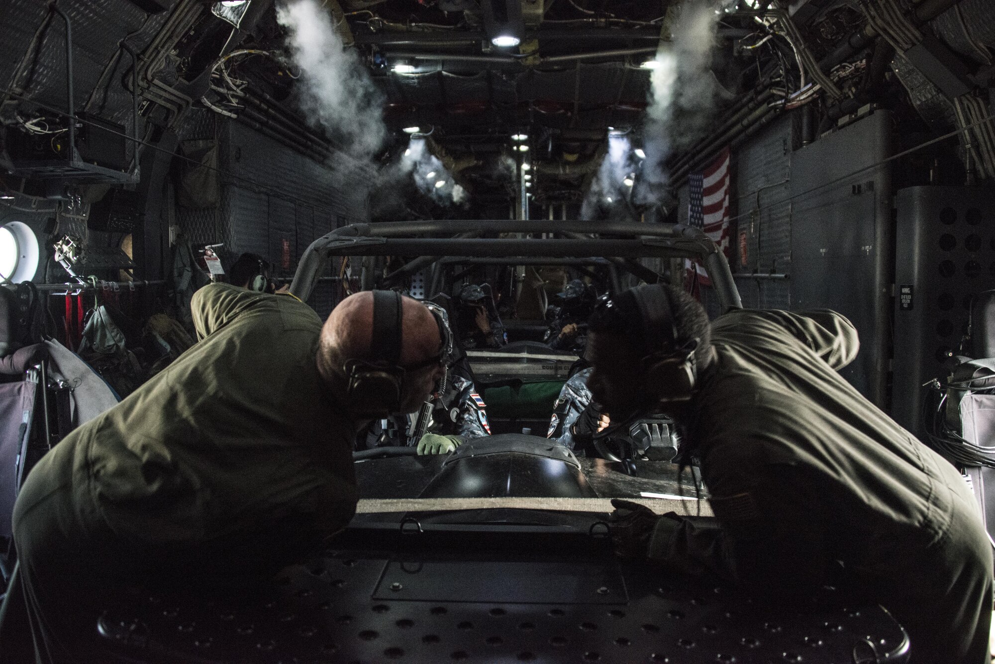 U.S. Air Force loadmasters assigned to the 1st Special Operations Squadron communicate prior to execution of a full mission profile conducted by Royal Thai Air Force 3rd Battalion Special Operations Regiment and U.S. Air Force 6th SOS, March 16, 2017 at Prachuap Khiri Khan, Thailand. Air commandos from the 1st SOS supported the training operations of the RTAF 3rd BN SOR and U.S. Air Force 6th SOS during the last week of Teak Torch 2017. (U.S. Air Force photo by Capt. Jessica Tait)