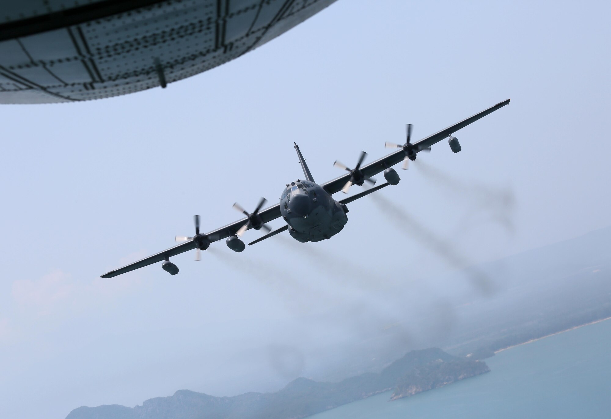 A U.S. Air Force MC-130H Talon II assigned to the 1st Special Operations Squadron flies visual formation with a Royal Thai Air Force C-130 assigned to the 601st Squadron, March 14, 2017 at Don Mueang Air Base, Thailand. A few first-ever engagements occurred during Teak Torch 2017 to include 353rd Special Operations Group members flying on a RTAF C-130, a U.S. and Thai formation flight and 353rd Special Operations Maintenance Squadron plugging a fuel quantity indicator test set into a Thai aircraft. (Courtesy photo by Royal Thai Air Force Public Affairs)