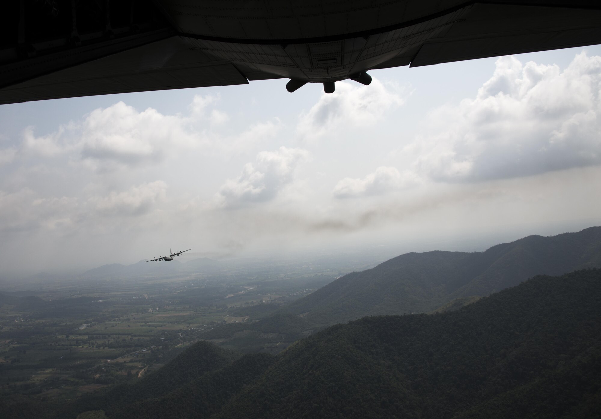 A Royal Thai Air Force C-130 assigned to the 601st Squadron flies visual formation with a U.S. Air Force MC-130H Talon II assigned to the 1st Special Operations Squadron, March 16, 2017 at Don Mueang Air Base, Thailand. The goal of the subject-matter expert exchanges during Teak Torch 2017 was to gain credibility and trust with the primary C-130 squadron in Thailand in order to strengthen the relationship of a longstanding U.S. ally. (U.S. Air Force photo by Capt. Jessica Tait)