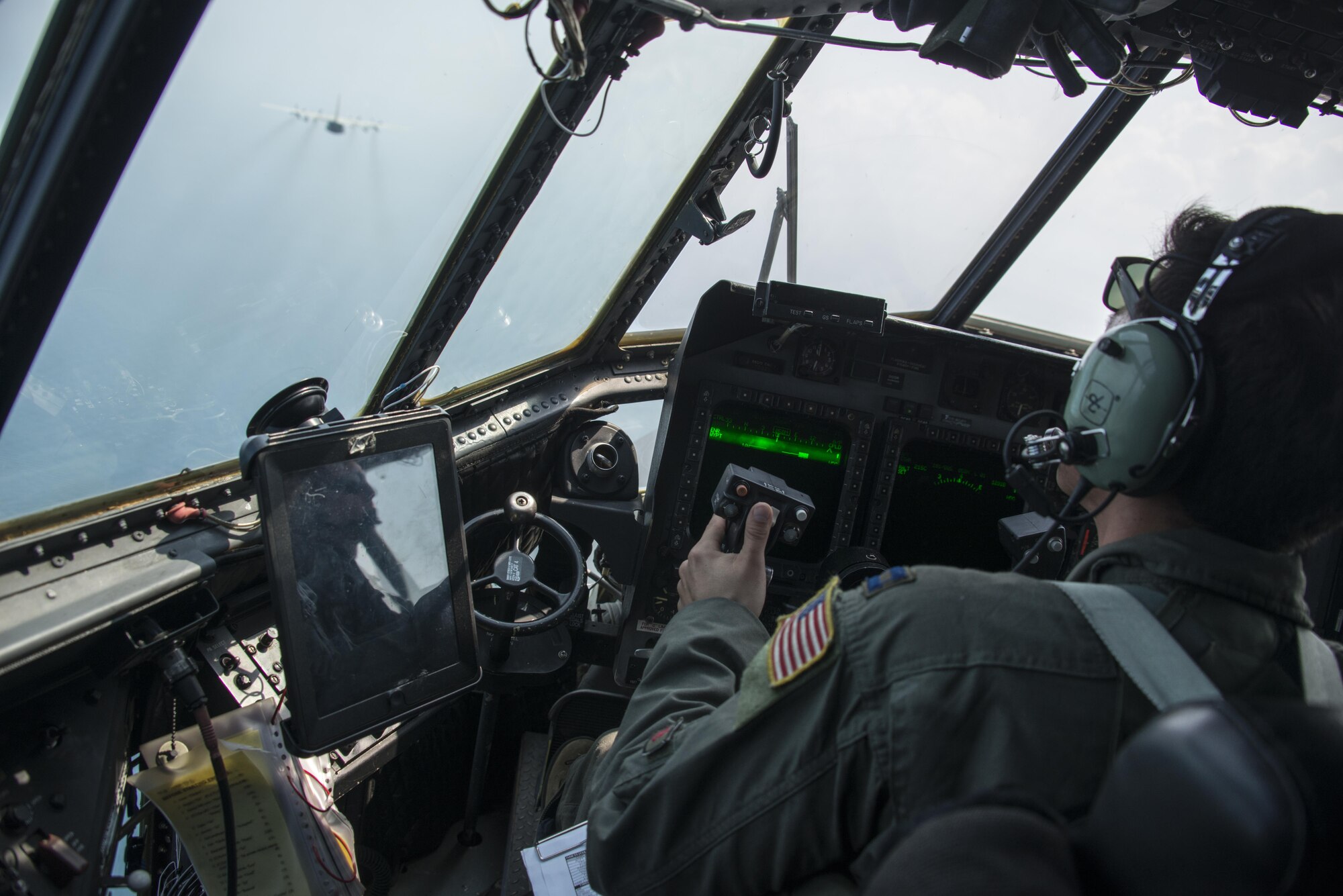 U.S. Air Force Capt. Scott Welshinger, 1st Special Operations Squadron pilot, flies the MC-130H Talon II during a formation flight with Royal Thai Air Force 601st Squadron, March 16, 2017 at Don Mueang Air Base, Thailand. A few first-ever engagements occurred during Teak Torch 2017 to include 353rd Special Operations Group members flying on a RTAF C-130, a U.S. and Thai formation flight and 353rd Special Operations Maintenance Squadron plugging a fuel quantity indicator test set into a Thai aircraft. (U.S. Air Force photo by Capt. Jessica Tait)