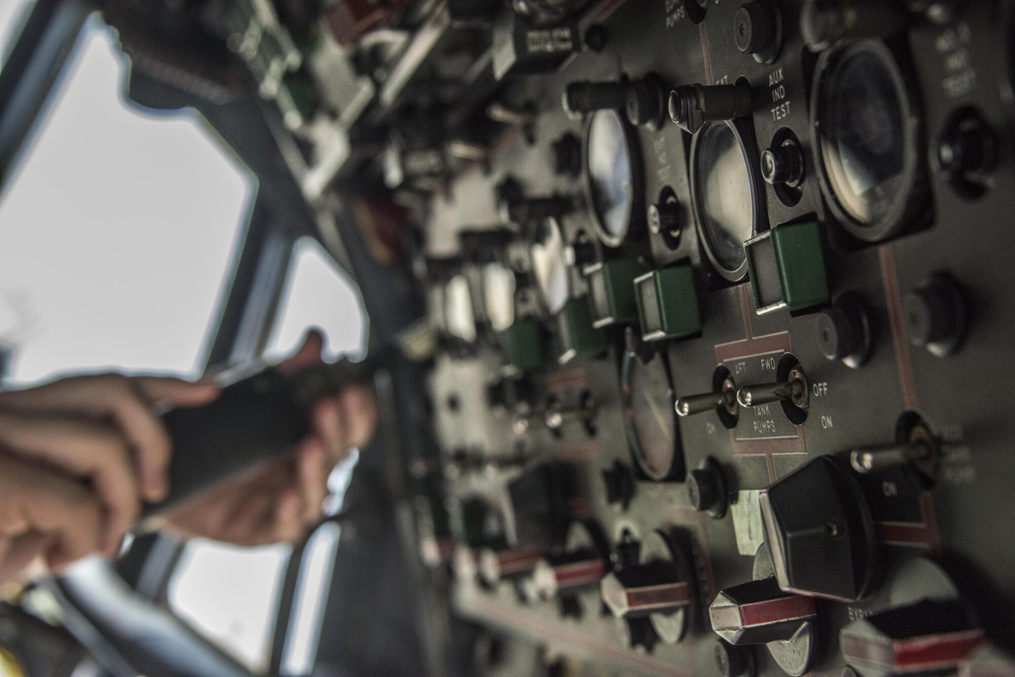 U.S. Air Force Staff Sgt. Kyle Johnson, 353rd Special Operations Maintenance Squadron guidance and control craftsman, disconnects a fuel quantity indicator from the overhead panel in the flight deck of an RTAF C-130H aircraft following a demonstration with the Royal Thai Air Force 601st Squadron Maintenance Team, March 15, 2017 at Don Mueang Air Base, Thailand. Teak Torch 2017 provided an opportunity for both the United States and partner nation to advance interoperability and partner capacity. (U.S. Air Force photo by Capt. Jessica Tait)