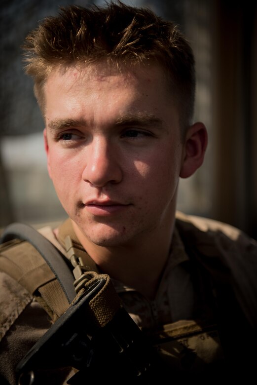Lance Cpl. Charley Cosper, 3rd Battalion, 7th Marines, assigned to the 407th Expeditionary Security Forces Squadron, poses for a photo at an entry control point at the 407th Air Expeditionary Group, March 28, 2017. The squadron has integrated U.S. Marine and Polish Airmen into the unit to enhance the mission of protecting joint and coalition assets. (U.S. Air Force photo/Master Sgt. Benjamin Wilson)(Released)