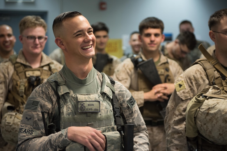 Airman 1st Class Troy Sears, 407th Expeditionary Security Forces Squadron, laughs while in formation for guard mount at the 407th Air Expeditionary Group, March 27, 2017. The squadron has integrated U.S. Marine and Polish Airmen into the unit to enhance the mission of protecting joint and coalition assets.  (U.S. Air Force photo/Master Sgt. Benjamin Wilson)(Released)