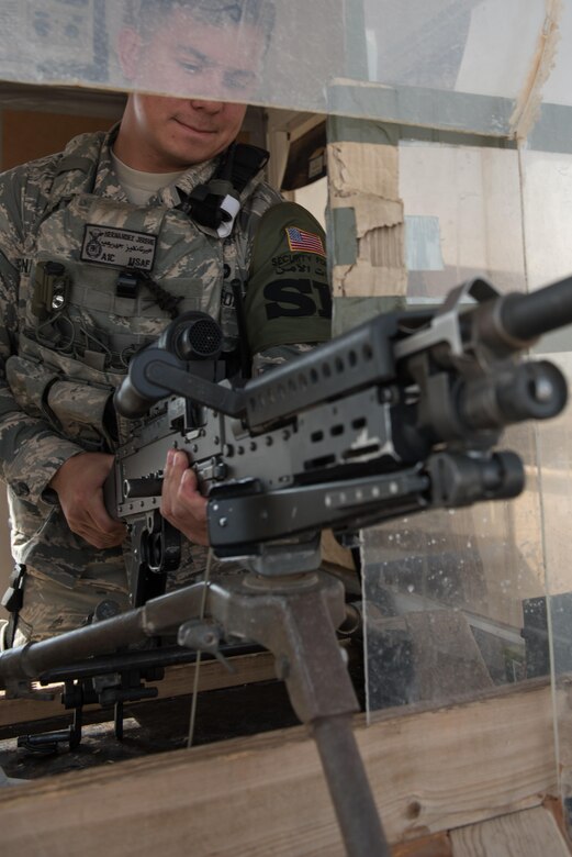 Airman 1st Class Jereme Hernandez, 407th Expeditionary Security Forces Squadron, mounts an M240B at the beginning of his shift at the 407th Air Expeditionary Group, March 28, 2017. The security forces squadron is responsible for security of U.S. Air Force, Marine, coalition and host-nation assets.  (U.S. Air Force photo/Master Sgt. Benjamin Wilson)(Released)