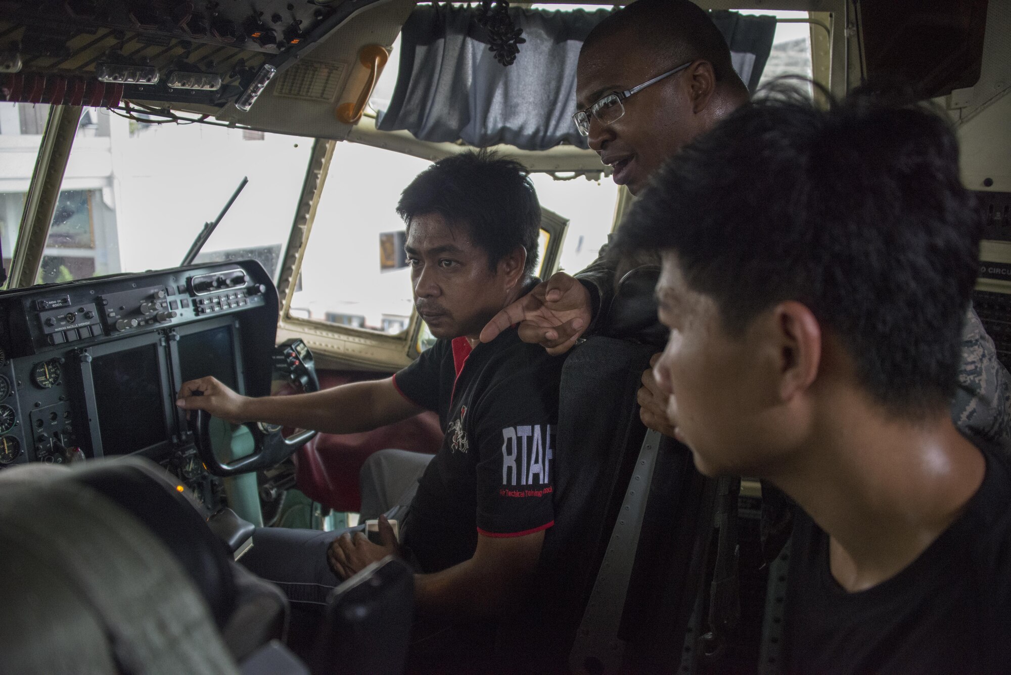 U.S. Air Force Capt. Ralph Toms III, USAF Maintenance Exchange Officer embedded with the Royal Thai Air Force 601st Squadron Maintenance Team, helps communicate the installation process of a PSD-90 Fuel Quantity Test Set to RTAF avionics maintainers, March 15, 2017 at Don Mueang Air Base, Thailand. During Teak Torch 2017, members of the 353rd SOMXS strengthened the long-standing partnership with the Royal Thai Air Force through subject-matter expert exchanges. (U.S. Air Force photo by Capt. Jessica Tait)