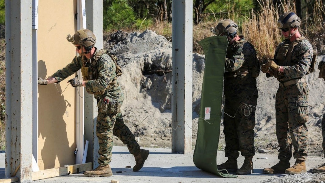 A Marine sets an explosive charge on a door during a breaching exercise at Marine Corps Base Camp Lejeune, N.C., March 30, 2017. The Marines and Sailors practiced techniques on how to successfully get through locked doors using shotguns and explosive charges. The Marines and sailors are with 2nd Reconnaissance Battalion. 